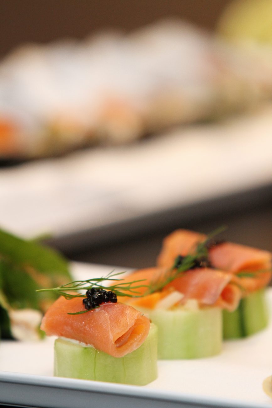 Canapes of smoked salmon and caviar on rounds of cucumber, with dill